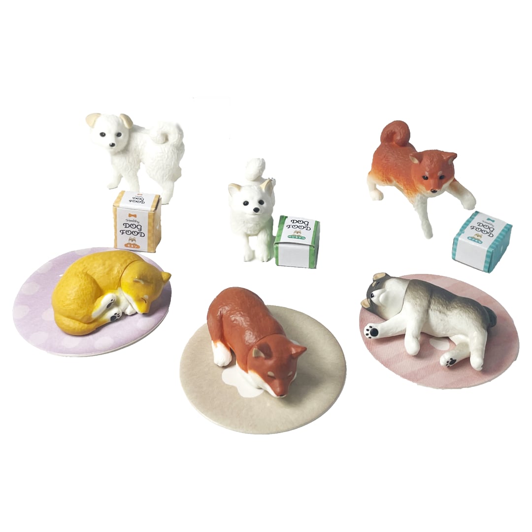 Six Shiba Inu puppy toy dog figurines and miniature cardboard accessories.
