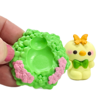 A hand hold the hexagonal garden base plate and a tiny toy duck peeks from behind.