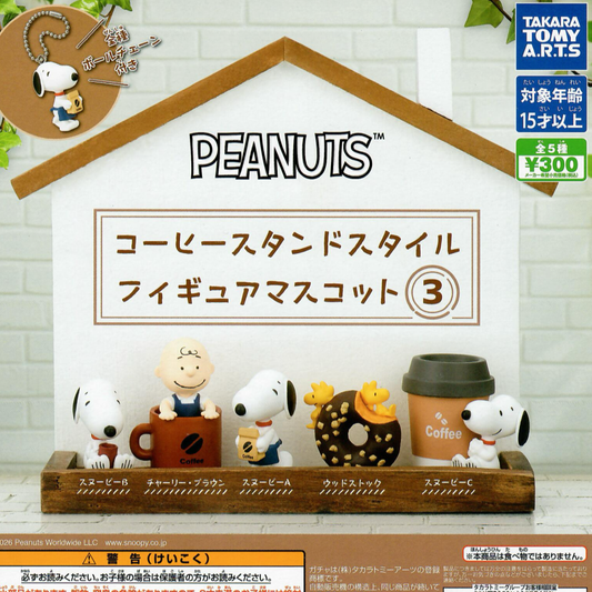 Peanuts coffee stand figurine set displayed on a wooden shelf against a white brick wall backdrop. The set includes five character figures and coffee-themed accessories, with Japanese text by Takara Tomy Arts