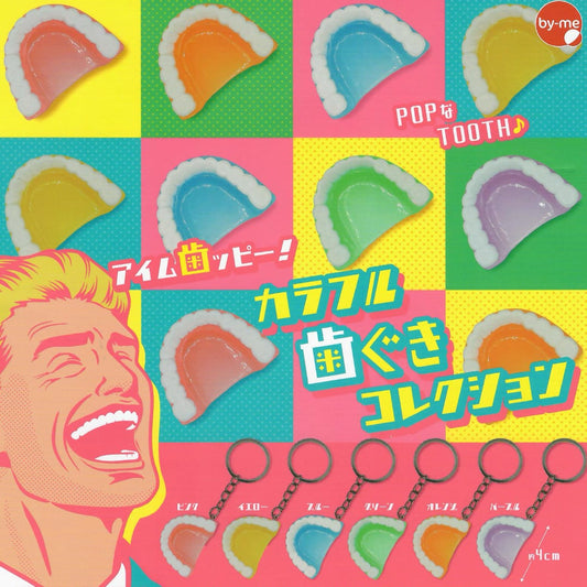 A colorful gachapon product collage showing multiple tooth-shaped keychains in different colors, with Japanese text and a stylized illustrated face. The keychains are arranged on a bright multicolor grid background.